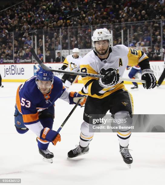 Casey Cizikas of the New York Islanders skates against Kris Letang of the Pittsburgh Penguins at the Barclays Center on March 20, 2018 in the...