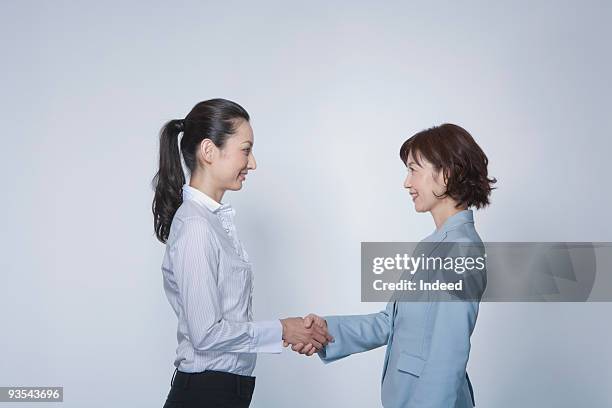 two businessmen shaking hands, profile - hair back side stock pictures, royalty-free photos & images