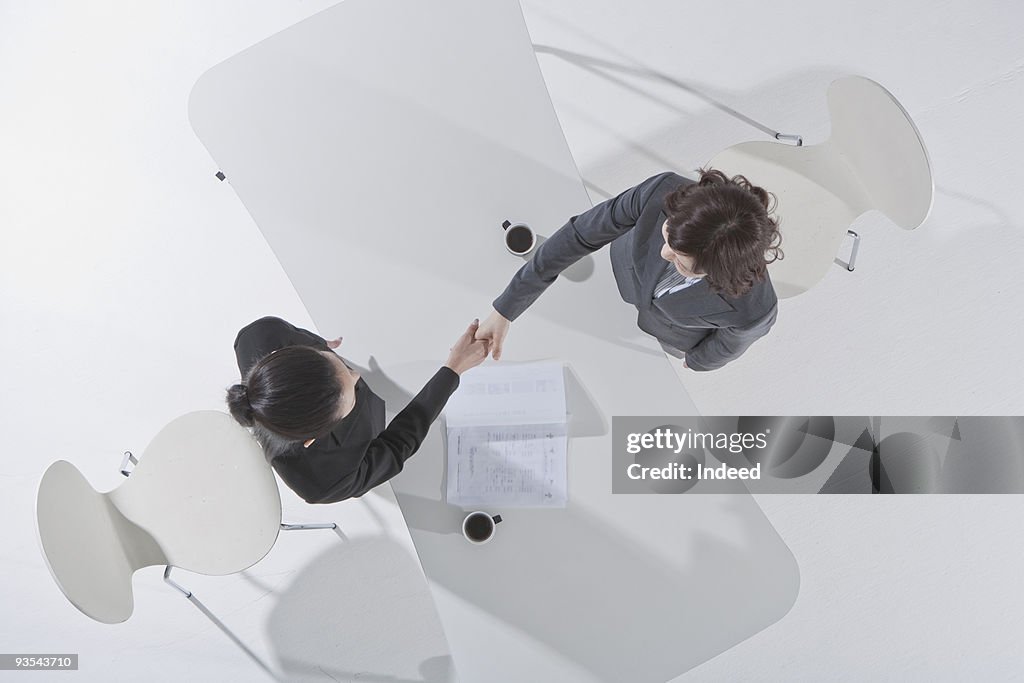 Two businesswoman shaking hands