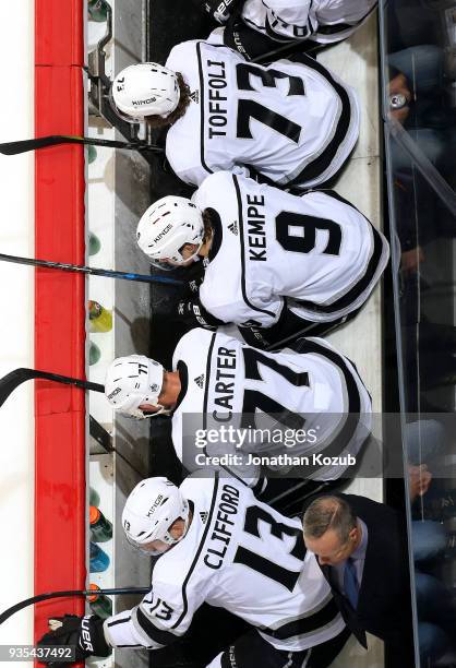 Tyler Toffoli, Adrian Kempe, Jeff Carter and Kyle Clifford of the Los Angeles Kings look on from the bench during second period action against the...