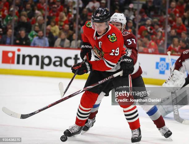 Jonathan Toews of the Chicago Blackhawks and J.T. Compher of the Colorado Avalanche battle for posession at the United Center on March 20, 2018 in...