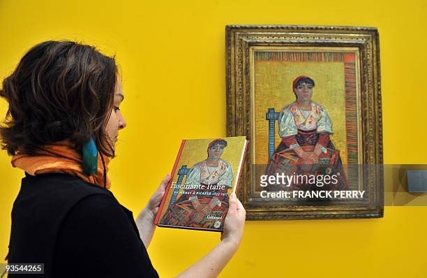 An employee holds a book as she stands in front of a painting 'The Italian woman' of Dutch painter Vincent Van Gogh at the Fine arts Museum of Nantes...