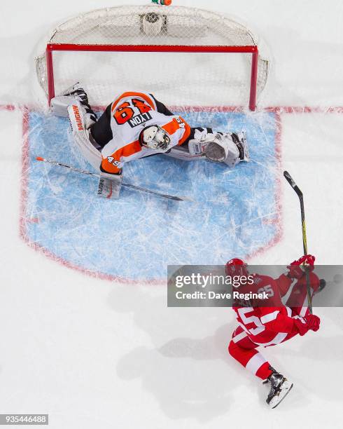 Alex Lyon of the Philadelphia Flyers makes a point blank save in overtime on Danny DeKeyser of the Detroit Red Wings during an NHL game at Little...