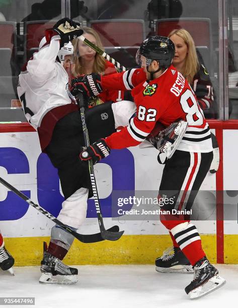 Jordan Oesterle of the Chicago Blackhawks hits Alexander Kerfoot of the Colorado Avalanche at the United Center on March 20, 2018 in Chicago,...
