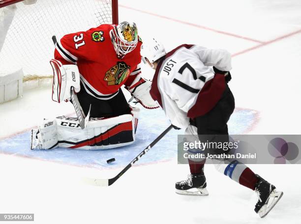 Anton Forsberg of the Chicago Blackhawks stops a shot by Tyson Jost of the Colorado Avalanche at the United Center on March 20, 2018 in Chicago,...