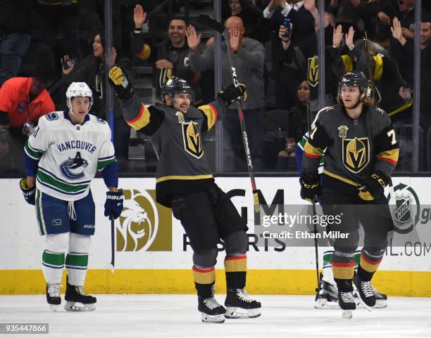 Tomas Tatar of the Vegas Golden Knights celebrates a first-period goal by teammate Jonathan Marchessault against the Vancouver Canucks as Troy...