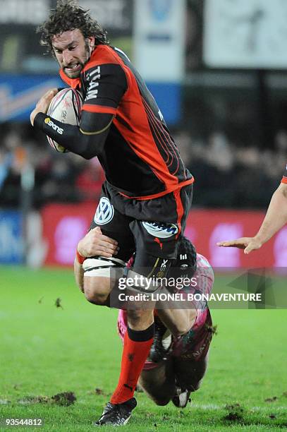 Toulon's flanker Ross Skeate is tackled by Paris' flanker James Haskell during the French Top 14 Rugby Union match Stade Francais vs Toulon on...