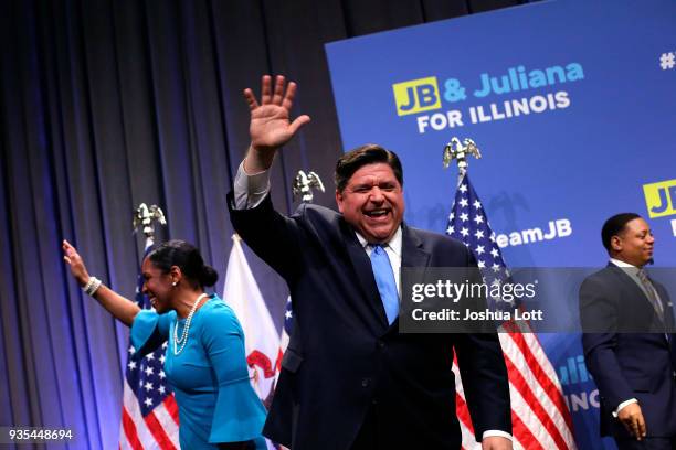 Illinois Democratic candidate for Governor J.B. Pritzker, center, and his Lieutenant Governor pick Juliana Stratton, left, wave to supporters during...