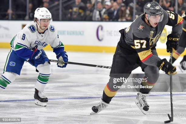 David Perron of the Vegas Golden Knights skates with the puck while Brendan Leipsic of the Vancouver Canucks defends during the game at T-Mobile...