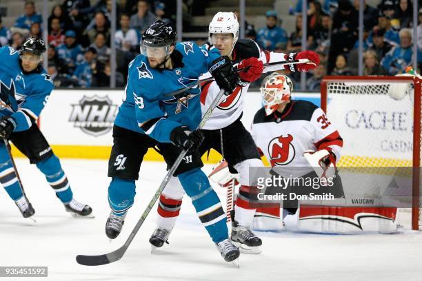 Ben Lovejoy of the New Jersey Devils defends Melker Karlsson of the San Jose Sharks at SAP Center on March 20, 2018 in San Jose, California.