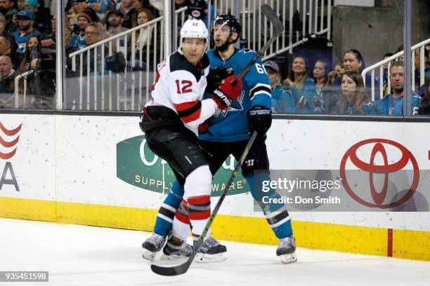 Ben Lovejoy of the New Jersey Devils defends Melker Karlsson of the San Jose Sharks at SAP Center on March 20, 2018 in San Jose, California.