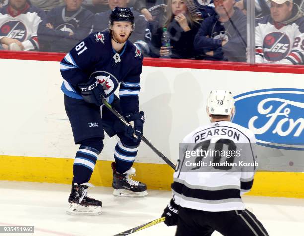 Kyle Connor of the Winnipeg Jets plays the puck along the boards as Tanner Pearson of the Los Angeles Kings defends during third period action at the...