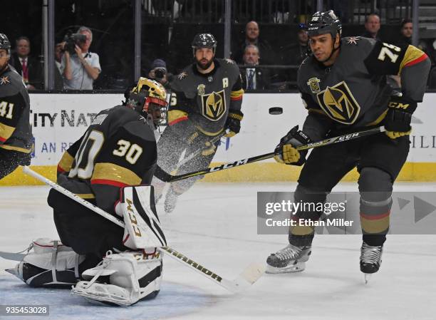 Malcolm Subban of the Vegas Golden Knights blocks a Vancouver Canucks' shot as Deryk Engelland and Ryan Reaves of the Golden Knights defend in the...