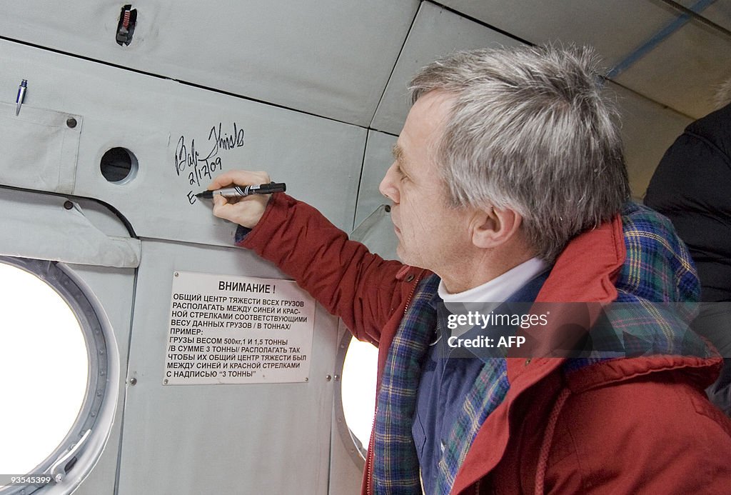 Canadian astronaut Robert Thirsk signs a