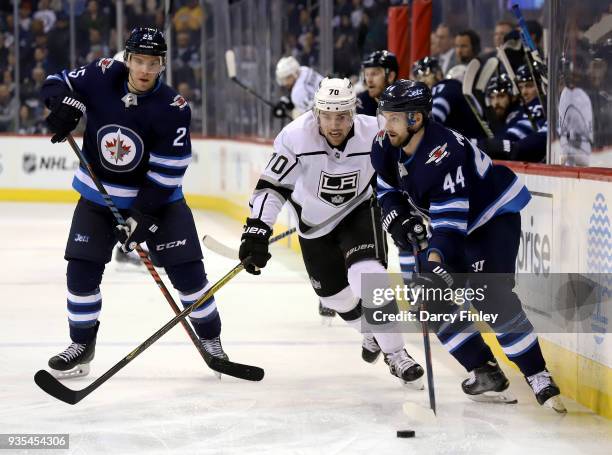 Josh Morrissey of the Winnipeg Jets plays the puck along the boards as Tanner Pearson of the Los Angeles Kings gives chase during third period action...