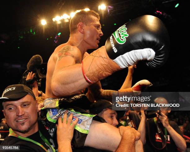 Australian titleholder Danny Green celebrates after defeating four-division world champion Roy Jones Jnr of the US in the IBO cruiserweight World...