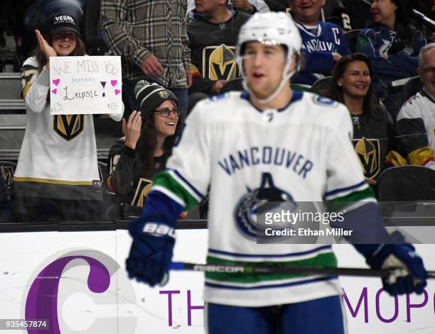 Fan holds up a sign for Brendan Leipsic of the Vancouver Canucks as the former Vegas Golden Knights player skates on the ice during a stop in play in...