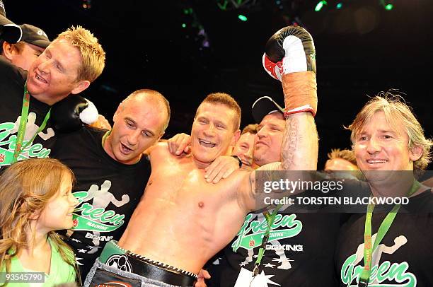 Australian titleholder Danny Green celebrates with his daughter Chloe and the Green Machine team after defeating four-division world champion Roy...