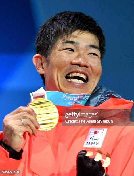 Gold medalist Yoshihiro Nitta of Japan celebrates on the podium at the medal ceremony for the Cross Country Men's 10km Classic - Standing on Day...