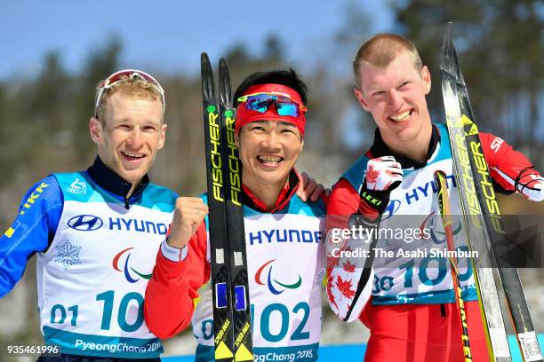 Silver medallist Grygorii Vovchynskyi of Ukraine, gold medalist Yoshihiro Nitta of Japan and Bronze medallist Mark Arendz of Canada pose during the...