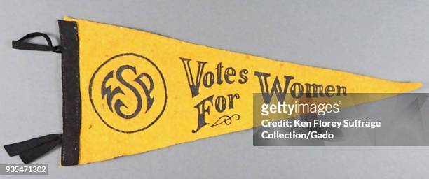 Black and yellow pennant or banner, produced for the American market, with the message "Votes for Women, " and a circular logo with the initials...