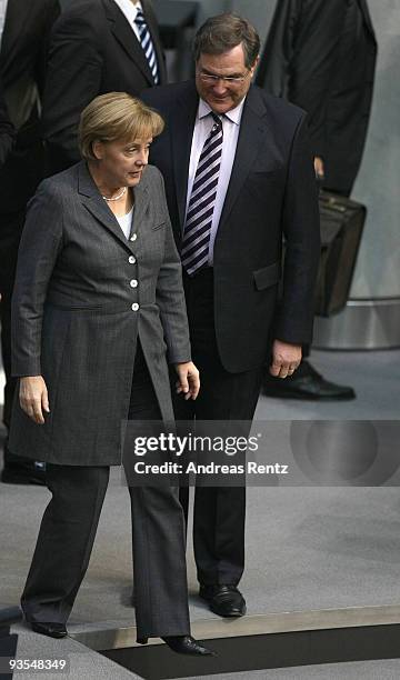 German Chancellor Angela Merkel chats with former Minister of Work and Social Issues Franz Josef Jung during a session at the German lower house of...