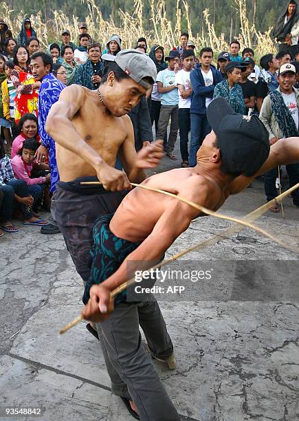 Two villagers hit each other using canes at Mount Bromo in Probolinggo, East Java province, on November 7, 2009. The fights were conducted as part of...