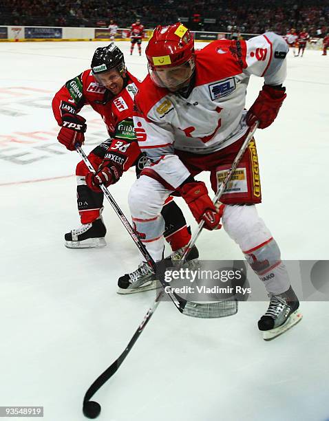 Dusan Frosch of Haie and Aris Brimanis of Scorpions in action during the Deutsche Eishockey Liga game between Koelner Haie and Hannover Scorpions at...