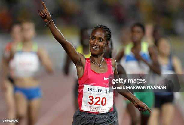 Ethiopia's Gelete Burka celebrates after winning the women's 1500m race during the Qatar Super Grand Prix in Doha late on May 8, 2009. AFP...