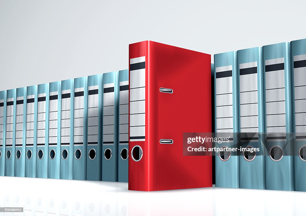 Red Lever Arch File in a Row of Grey Files