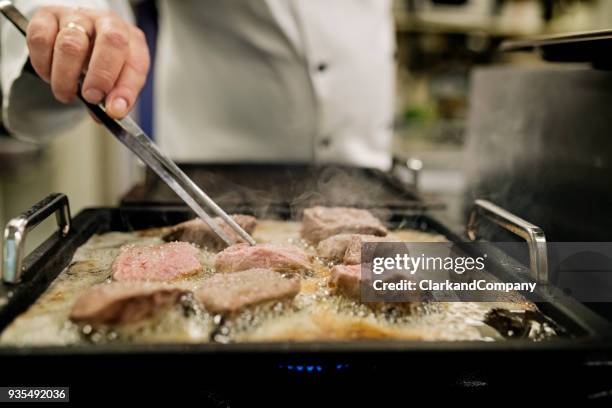 professional chef at work - commercial griddle stock pictures, royalty-free photos & images