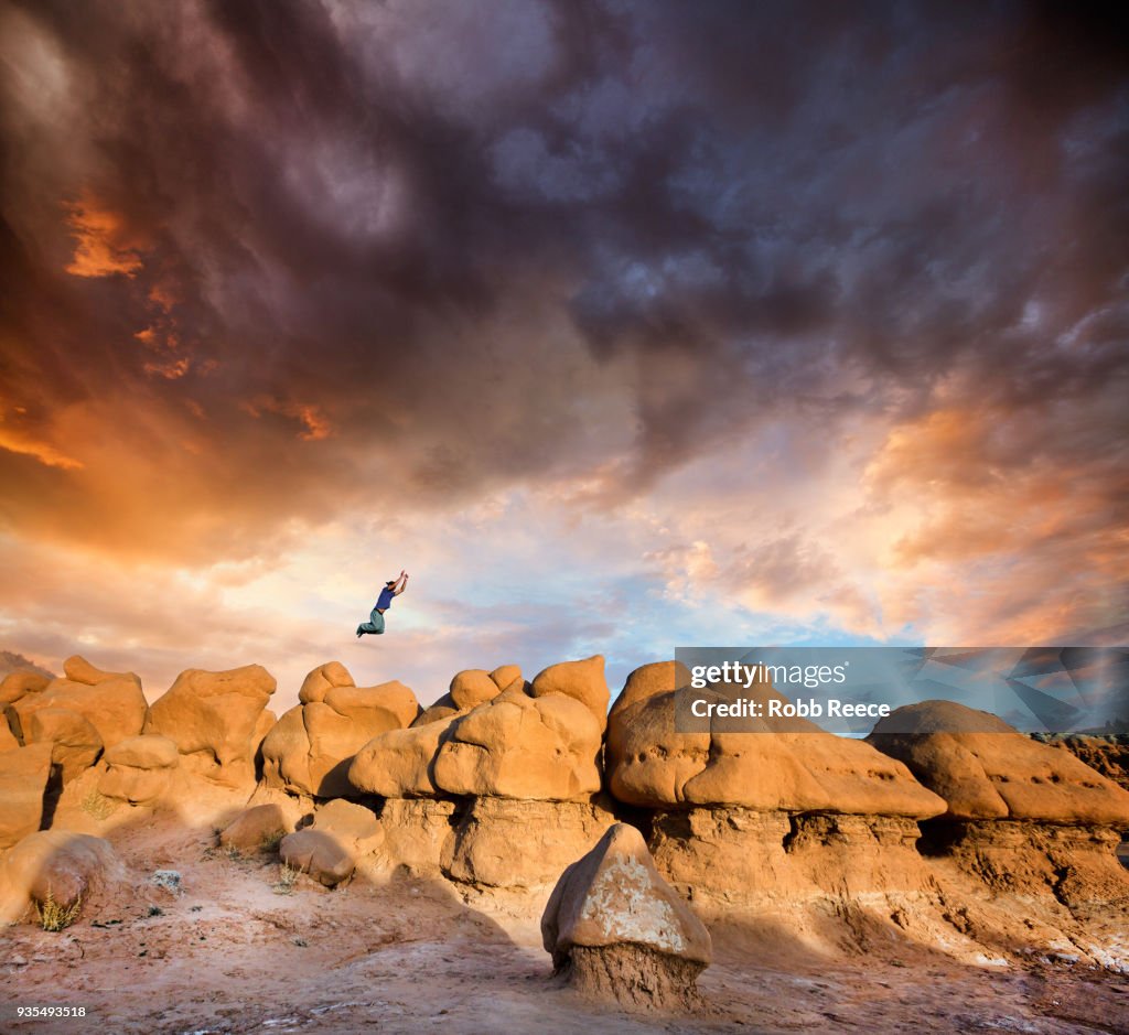 A man doing Parkour on rocks in the desert