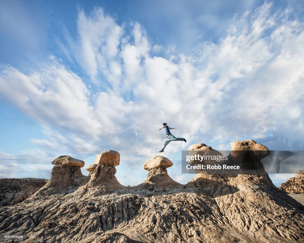 A man doing Parkour on rocks in the desert
