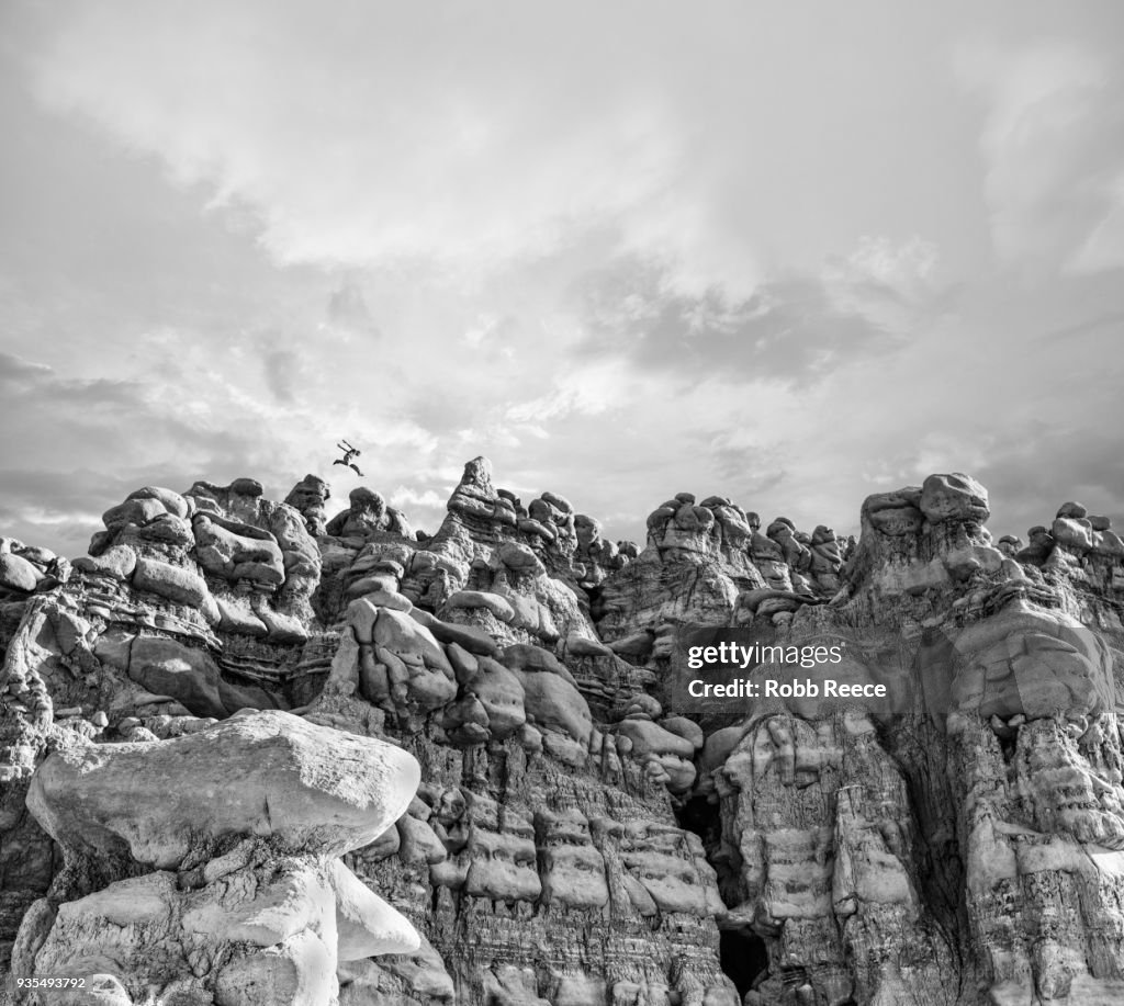 A man doing Parkour on rocks in the desert