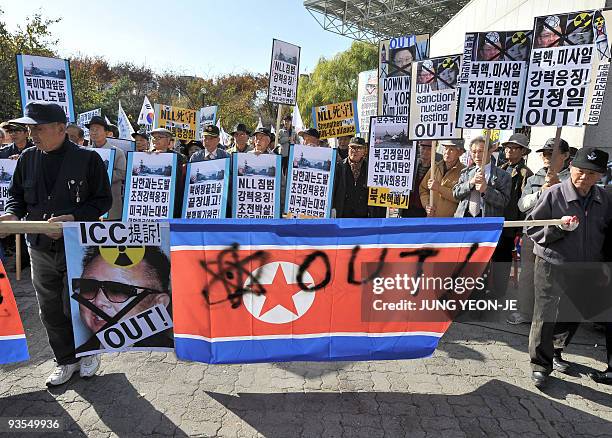 South Korean conservative activists carry a North Korean flag during a rally in Seoul on November 11, 2009 denouncing a sea clash between South and...