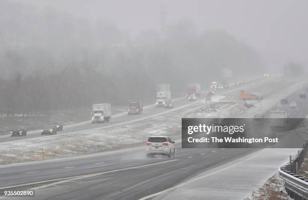 Traffic is seen on Interstate 70 looking west as precipitation begins to fall on March 20, 2018 in Myersville, Md.