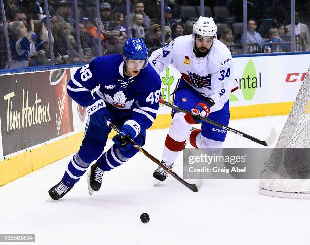 Calle Rosen of the Toronto Marlies controls the puck against David Broll of the Laval Rocket during AHL game action on March 12, 2018 at Air Canada...