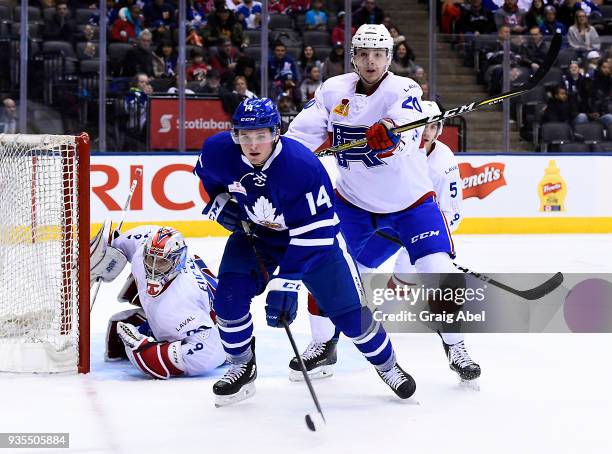 Goalie Zachary Fucale and Etienne Boutet of the Laval Rocket defend against Adam Brooks of the Toronto Marlies during AHL game action on March 12,...