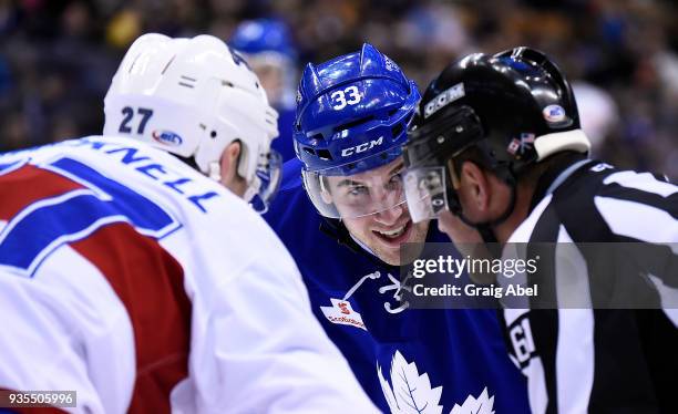 Frederick Gauthier of the Toronto Marlies and Adam Cracknell of the Laval Rocket have a chuckle with linesman Kevin Hastings during AHL game action...