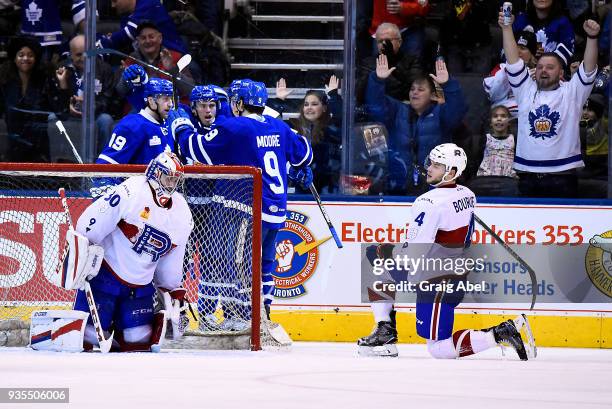 Trevor Moore and Chris Mueller of the Toronto Marlies celebrate a Marlie goal while goalie Zachary Fucale and Simon Bourque the Laval Rocket look on...