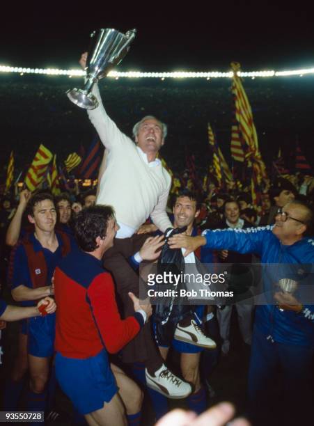 Barcelona coach Udo Lattek, holding the Cup Winners Cup, is carried by his players after the European Cup Winners Cup Final against Standard Liege...