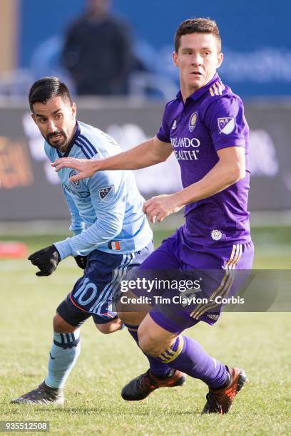 March 11: Will Johnson of Orlando City and Maximiliano Moralez of New York City challenge for the ball during the New York City FC Vs Orlando City SC...