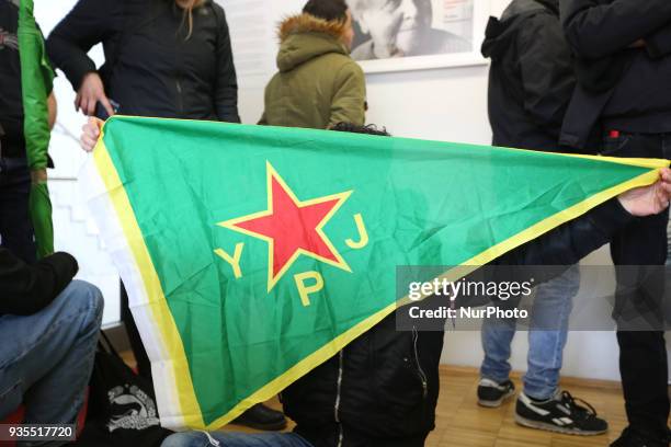 Activist holds flag of the women's defense unit during the block, in Munich, Germany, on March 20, 2018. About 20 pro-kurdish activists blocked the...