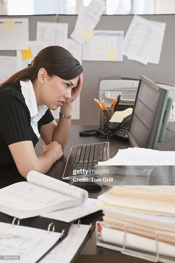 Stressed woman at messy desk