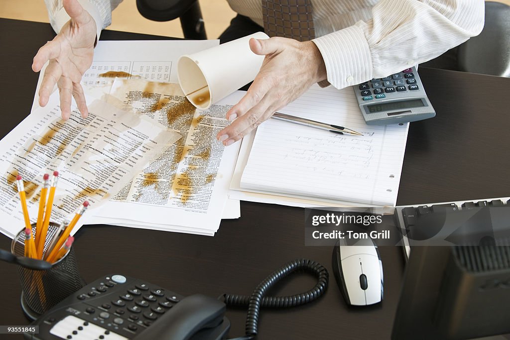 Spilled coffe on business desk