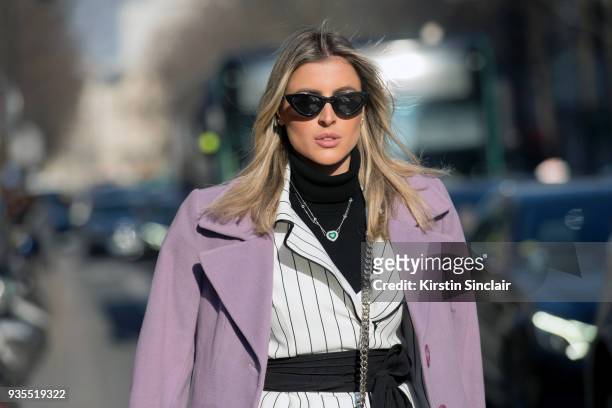Fashion and Lifestyle blogger Dandynha Barbosa wears a Ton Age suit, Adam Selman for Le Specs sunglasses day 3 of Paris Womens Fashion Week...