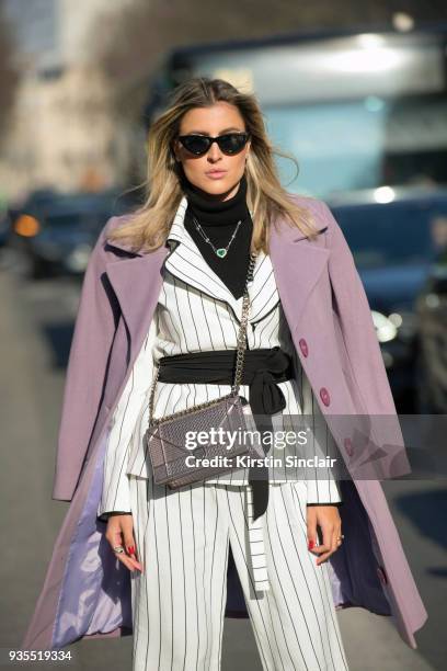 Fashion and Lifestyle blogger Dandynha Barbosa wears a Dior bag, Ton Age suit, Adam Selman for Le Specs sunglasses day 3 of Paris Womens Fashion Week...