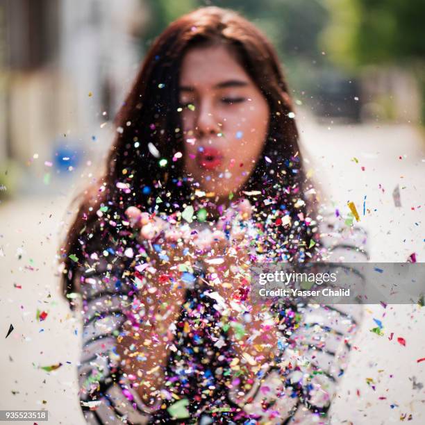 girl blowing glitter - kids fun indonesia stock-fotos und bilder