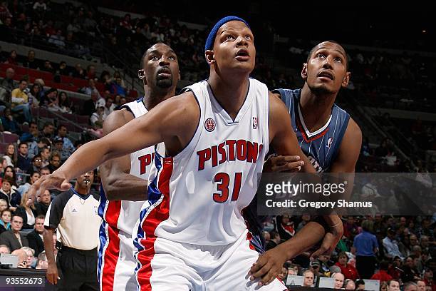 Ben Gordon and Charlie Villanueva of the Detroit Pistons look for the rebound against Boris Diaw of the Charlotte Bobcats during the game on November...
