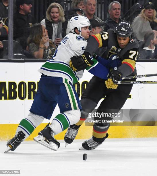 Ryan Reaves of the Vegas Golden Knights tries to get by Derrick Pouliot of the Vancouver Canucks in the second period of their game at T-Mobile Arena...